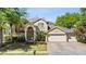 Beautiful two-story home with a three-car garage and a well-maintained lawn at 3344 Quailwest Ct, Orlando, FL 32812