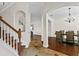 Inviting foyer with staircase and views to the dining room for entertaining at 3344 Quailwest Ct, Orlando, FL 32812