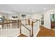 Bright hallway with hardwood floors, white railings, and elegant lighting fixtures at 3344 Quailwest Ct, Orlando, FL 32812