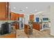 Bright kitchen features wood cabinets, stainless appliances, stone floors, granite countertops, and leads to the living room at 3344 Quailwest Ct, Orlando, FL 32812