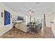 An open living room area with tile floors, neutral walls, three sofas, and outdoor access at 3344 Quailwest Ct, Orlando, FL 32812