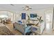 The living room features neutral-colored walls, tile flooring, three sofas and flows into the dining area at 3344 Quailwest Ct, Orlando, FL 32812