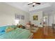 Main bedroom offers hardwood floors, tray ceiling, ceiling fan, and bright walls with art on display at 3344 Quailwest Ct, Orlando, FL 32812
