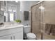 Bright bathroom featuring a walk-in shower with glass door, white vanity, and tiled floors at 3375 Hanging Tide St, Winter Garden, FL 34787