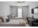 Comfortable bedroom with ceiling fan, a desk, two twin beds, and neutral colored walls at 3375 Hanging Tide St, Winter Garden, FL 34787