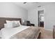 Bedroom with a padded headboard, a ceiling fan, neutral colored linens and an attached bathroom at 3375 Hanging Tide St, Winter Garden, FL 34787