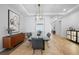 Elegant dining room with modern lighting, wood-look tile floors, stylish decor and modern accents at 3375 Hanging Tide St, Winter Garden, FL 34787