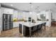 Modern kitchen featuring stainless steel appliances, a large center island with bar seating, and stylish pendant lighting at 3375 Hanging Tide St, Winter Garden, FL 34787
