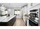 Modern kitchen featuring stainless steel appliances, a large center island with bar seating, and stylish pendant lighting at 3375 Hanging Tide St, Winter Garden, FL 34787