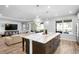 Modern kitchen island featuring a marble countertop and decorative pendant lighting open to the living room at 3375 Hanging Tide St, Winter Garden, FL 34787