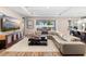 Spacious living room with a large sectional sofa, wood-look flooring and plenty of natural light at 3375 Hanging Tide St, Winter Garden, FL 34787