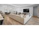 Spacious living room with a large sectional sofa, wood-look flooring and plenty of natural light at 3375 Hanging Tide St, Winter Garden, FL 34787