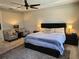 Spacious main bedroom featuring a king bed with padded headboard, ceiling fan and two comfy chairs at 3375 Hanging Tide St, Winter Garden, FL 34787