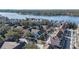 An aerial view of a lakeside community featuring lush trees, well-maintained landscaping, and ample parking at 3384 Corona Village Way # 202, Orlando, FL 32835