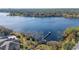 Aerial view of the lake with pier and gazebo in this lakeside community surrounded by lush landscaping at 3384 Corona Village Way # 202, Orlando, FL 32835