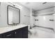 Bathroom with updated vanity, framed mirror, and shower-tub combo at 3384 Corona Village Way # 202, Orlando, FL 32835