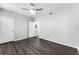 This bedroom features a ceiling fan and dark wood laminate flooring at 3384 Corona Village Way # 202, Orlando, FL 32835
