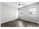 Neutral bedroom features a closet and two windows with wood-look floors at 3384 Corona Village Way # 202, Orlando, FL 32835