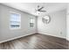 Bright bedroom features wood-look floors, two windows, and a ceiling fan at 3384 Corona Village Way # 202, Orlando, FL 32835