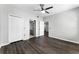 Neutral bedroom features a closet and attached bathroom with wood-look floors at 3384 Corona Village Way # 202, Orlando, FL 32835