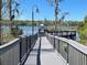 Picturesque boardwalk leading to the lake, offering scenic views of the water at 3384 Corona Village Way # 202, Orlando, FL 32835