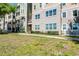 The building's exterior is accessible via sidewalks and stairs with lush landscaping, offering convenient access at 3384 Corona Village Way # 202, Orlando, FL 32835