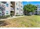 A lovely angle of the building with nicely manicured bushes in front of the property on a sunny day at 3384 Corona Village Way # 202, Orlando, FL 32835