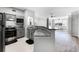 Open kitchen with granite countertops, stainless steel appliances, and view to the living room at 3384 Corona Village Way # 202, Orlando, FL 32835