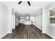 Spacious living room with dark wood floors, kitchen view, and plenty of natural light at 3384 Corona Village Way # 202, Orlando, FL 32835