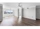 Spacious, light-filled living room with hardwood flooring and large windows overlooking the lake at 3384 Corona Village Way # 202, Orlando, FL 32835