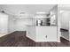 Open-concept living room with dark wood floors and modern finishes at 3384 Corona Village Way # 202, Orlando, FL 32835