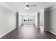 Spacious living room with large windows, ceiling fan, and hardwood floors at 3384 Corona Village Way # 202, Orlando, FL 32835