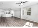 Open living room featuring hardwood floors, a ceiling fan, and an adjacent kitchen at 3384 Corona Village Way # 202, Orlando, FL 32835