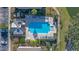 Overhead aerial view of rectangular pool and hot tub surrounded by lounge chairs and a paved deck area at 3384 Corona Village Way # 202, Orlando, FL 32835