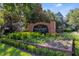 Attractive community entrance sign surrounded by lush bushes and landscaping at 3384 Corona Village Way # 202, Orlando, FL 32835