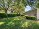 Lush backyard with mature trees and manicured hedges providing privacy and shade at 3400 Park Grove Ct, Longwood, FL 32779