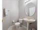 Half-bathroom featuring a toilet, pedestal sink with a gold faucet, and an oval mirror at 3400 Park Grove Ct, Longwood, FL 32779