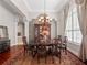 Elegant dining room with a chandelier, wood table, and decorative rug for formal gatherings at 3400 Park Grove Ct, Longwood, FL 32779