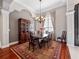 Elegant dining room with a wooden table, ornate chandelier, and a patterned rug at 3400 Park Grove Ct, Longwood, FL 32779