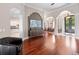 Spacious foyer with hardwood floors, decorative columns, and open sightlines to the dining area and kitchen at 3400 Park Grove Ct, Longwood, FL 32779
