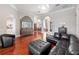 Elegant entryway showcasing hardwood floors, open floor plan, and seamless transition to dining and living spaces at 3400 Park Grove Ct, Longwood, FL 32779