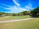 Scenic golf course view featuring manicured greens and sand traps under a bright blue sky at 3400 Park Grove Ct, Longwood, FL 32779