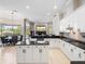 Bright kitchen featuring white cabinets, black countertops, and a spacious breakfast area at 3400 Park Grove Ct, Longwood, FL 32779
