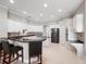 Spacious kitchen featuring white cabinets, stainless steel appliances, and a large island at 3400 Park Grove Ct, Longwood, FL 32779
