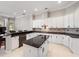 Elegant kitchen featuring white cabinetry, dark countertops, and tile backsplash at 3400 Park Grove Ct, Longwood, FL 32779