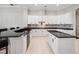 Stylish kitchen boasts white cabinetry, dark countertops, and modern appliances at 3400 Park Grove Ct, Longwood, FL 32779