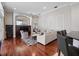 Open-concept living room featuring hardwood floors, cozy furniture, and a decorative media center at 3400 Park Grove Ct, Longwood, FL 32779