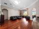 Spacious living room with hardwood floors, a comfortable sofa, and large windows overlooking the backyard at 3400 Park Grove Ct, Longwood, FL 32779