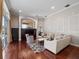 Open-concept living room featuring hardwood floors, a large window, and a comfortable sofa at 3400 Park Grove Ct, Longwood, FL 32779