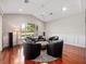 Bright living room with hardwood floors, a ceiling fan, and many windows offering a serene outdoor view at 3400 Park Grove Ct, Longwood, FL 32779